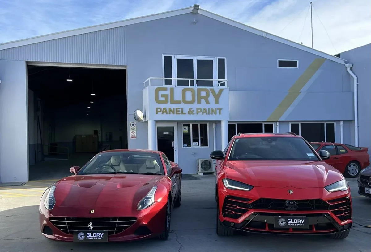 Ferrari and Lamborghini Urus outside the GLORY Panel & Paint workshop, Christchurch